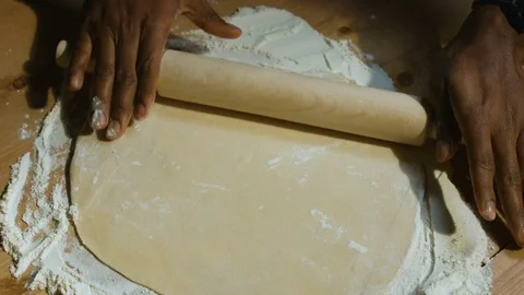Hands of black man prepare dough for dumplings Stock Footage 83853165