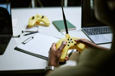 Hands of Black Man Testing Drone Remote Controller at Tech Lab Stock Photos