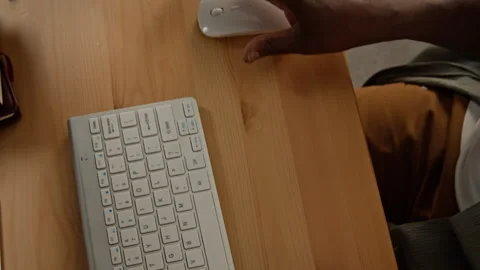 Hands of Black Man Using Computer Mouse for Online Work from Home Stockbeeldmateriaal 347646700