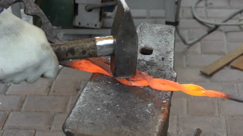 Hands of a blacksmith forging rod Stock Footage 34884153