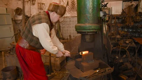Hands of a blacksmith with a tool Stock Footage 108618944