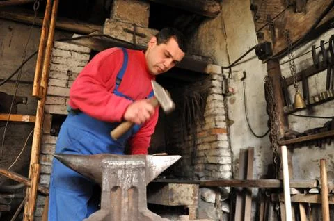 Hands of blacksmith working iron Stock Photos