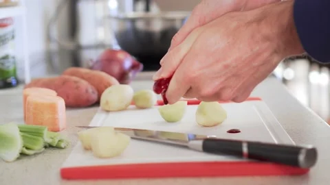 Hands with bleeding finger cut while slicing vegetables, close up Stock Footage 205786667