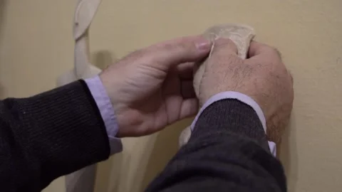 Hands of blind man touching a copy of a Cycladic statue Stock Footage 140986565