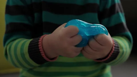 Hands with blue and red slime close up. Girl and boy preschool minor stretching Stock-Footage 148140030