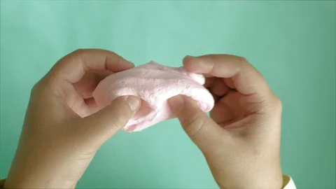 Hands on a blue background use multi-colored soft clay for modeling. Creative Stock-Footage 111048857