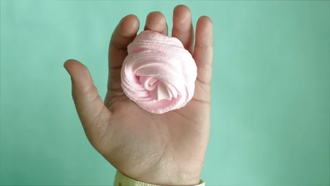 Hands on a blue background use multi-colored soft clay for modeling. Creative Stock Footage 111245743