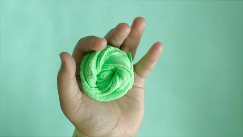 Hands on a blue background use multi-colored soft clay for modeling. Creative Stock-Footage 111245791