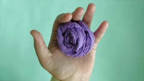 Hands on a blue background use multi-colored soft clay for modeling. Creative Stock-Footage 111245804