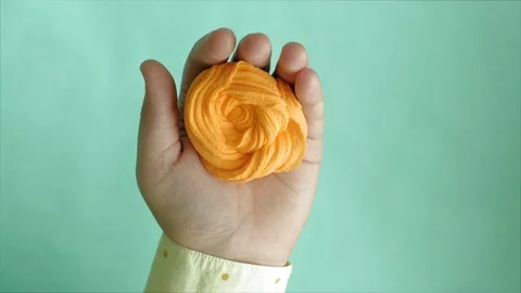 Hands on a blue background use multi-colored soft clay for modeling. Creative Stock-Footage 111246014