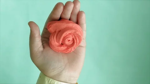 Hands on a blue background use multi-colored soft clay for modeling. Creative Stock-Footage 111246232