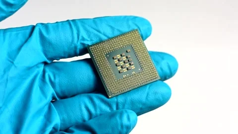 Hands in blue gloves hold a microchip. CPU in the hands. Stock Footage 139301953