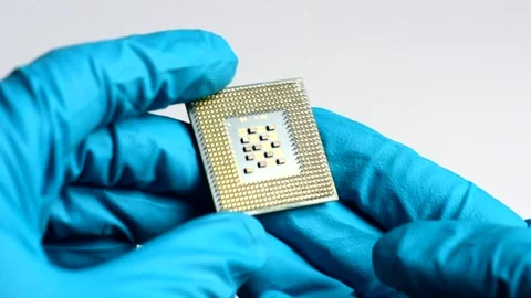 Hands in blue gloves hold a microchip. CPU in the hands. Stock Footage 139301974