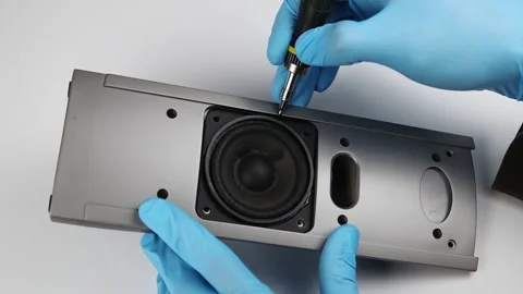 Hands in blue gloves pull the music speaker out of the case. FullHD Vídeo Stock 141121402