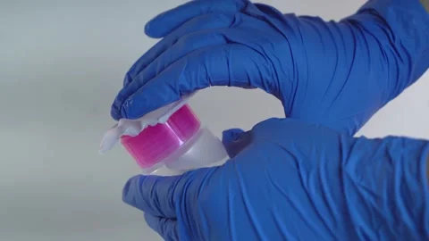 Hands in blue gloves use antiseptic, emphasizing cleanliness and sterility. Stock Footage 295212586