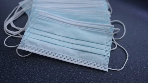 Hands with blue protective nitride gloves holding N95, respirator, face mask Stock Footage 127505434