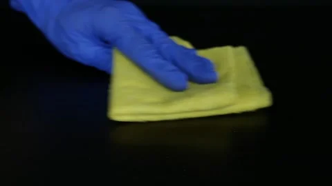 Hands in blue rubber gloves wipe the dust with a yellow cloth. Cleaning Stock Footage 105959993