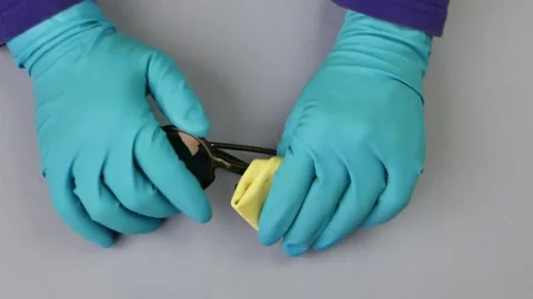 Hands in blue rubber gloves wipe sunglasses. Stock Footage 265662930