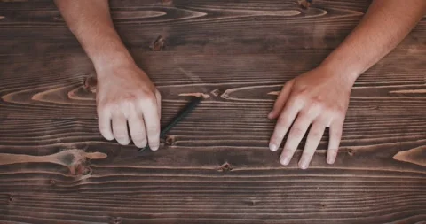 Hands of a bored man. Fingers tapping on table. Playing with pen. Top view. Video stock 263018742