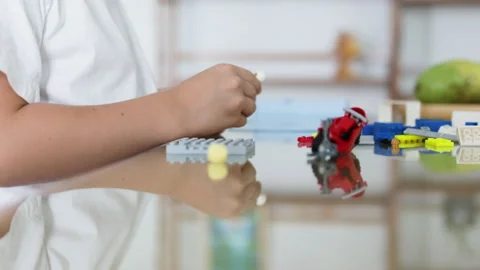 Hands of boy constructing blocks on table. Video stock 265541759