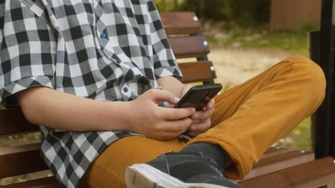 Hands of a boy holding smart phone Stock Footage 145306091