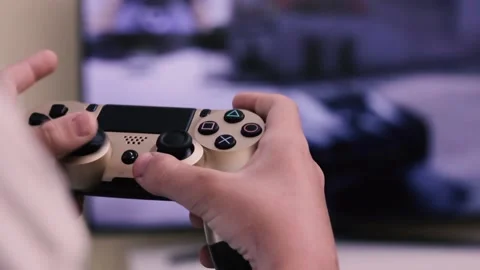 Hands of boy press the buttons on the console of the game console against the bi Stock Footage 198482257