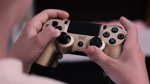 Hands of boy press the buttons on the console of the game console against the Stock Footage 199235885