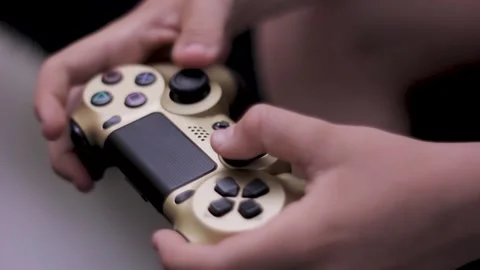 Hands of boy push buttons on console against big TV screen Stock Footage 200255451