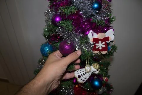 Hands of a boy while decorating the Christmas tree Stock Photos
