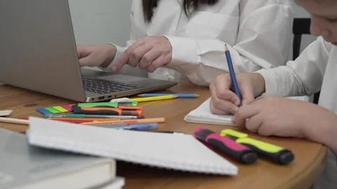 Hands of a boy who draws while his mother is working at a computer 스톡 동영상 258636458