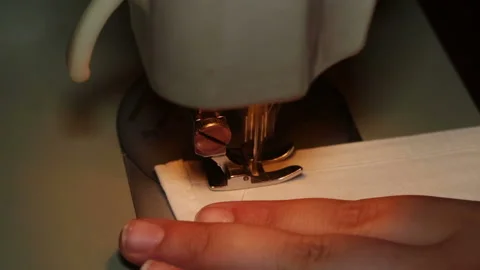 Hands of a boy who is taught to use the sewing machine to sew the medical mask 스톡 동영상 130843775