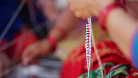 Hands braid bead thread in close up during necklace weaving Stock-Footage 342399197