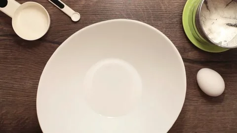 Hands break an egg in a bowl Stock Footage 130604345