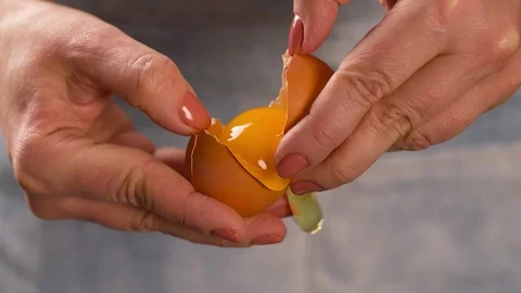Hands break egg Close up Macro shot Slow motion Stock Footage 103041232
