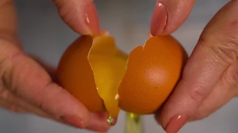 Hands break egg Extremely Close up Macro shot Slow motion Stock Footage 103041315