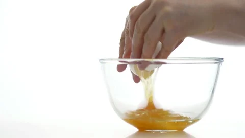 Hands break the eggs into a bowl Stock Footage 89424743