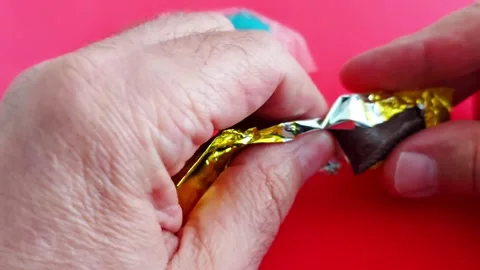 Hands Break Open Jelly Candy on Red Background Vídeo Stock 309177606