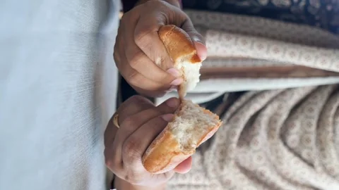 Hands breaking apart soft bread roll revealing airy texture. Stock Footage 333156034
