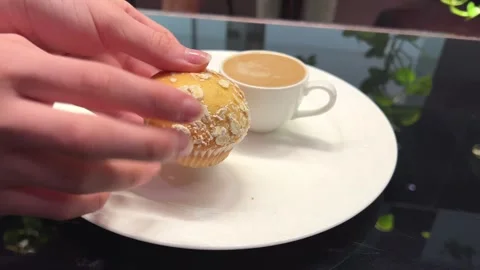 Hands breaking a cupcake Freshly baked healthy muffin is shown and held in the 스톡 동영상 276532028