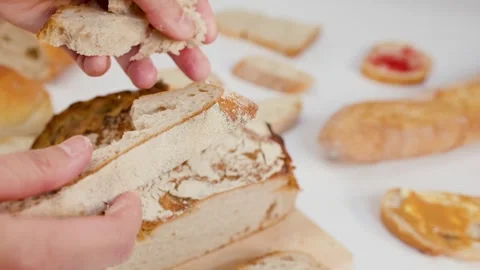 Hands Breaking Fresh Sourdough Bread Loaf on White Background Stock Footage 337917853