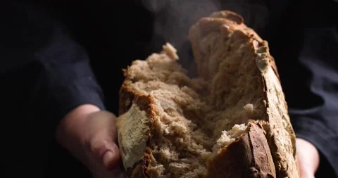 Hands breaking freshly baked bread Stock Footage 254690567