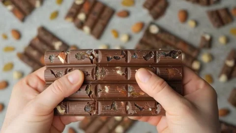 Hands Breaking Nut Chocolate Bar, Slow Motion. Video stock 294044943