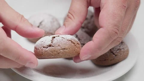 Hands Breaking Powdered Chocolate Cookie Stock Footage 327910679