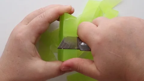 Hands breaking a translucent green soap into small chunks. Stock Footage 313356031