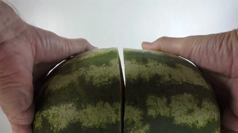 Hands breaking a watermelon in 4K Stock Footage 138685412