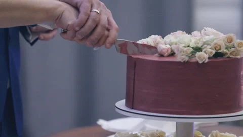 Hands of the bride and groom cut the wedding cake. close-up. slow motion video Stock Footage 147678598