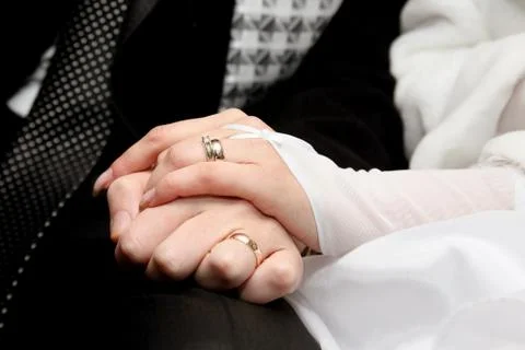 Hands of the bride and groom together Stock Photos