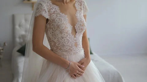 Hands of a bride close-up lie on a white  wedding dress Stock Footage 119532719