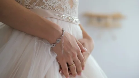 Hands of a bride close-up lie on a white  wedding dress Stock Footage 119532863