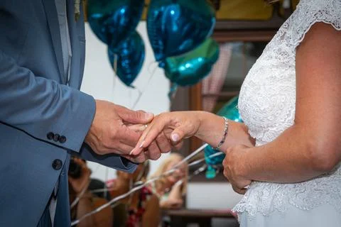 Hands of a bride getting wedding ring Stock Photos